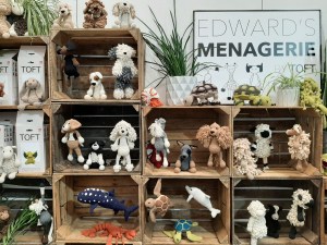 A display of knitted and crochet toy animals including a poodle, a whale and a lobster.